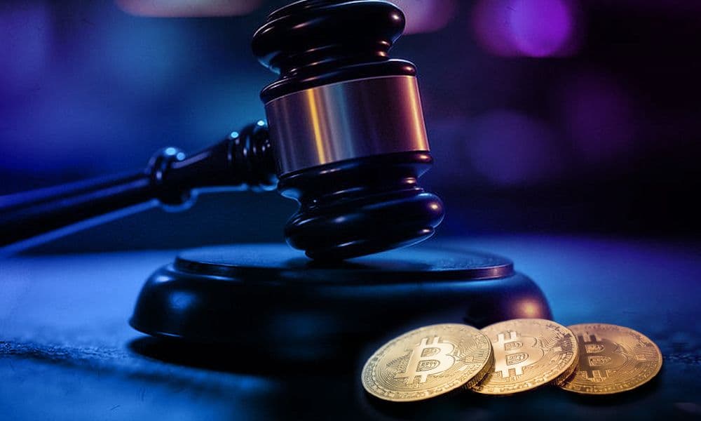 Judge's gavel beside three Bitcoin coins symbolizing cryptocurrency regulation and legal issues.